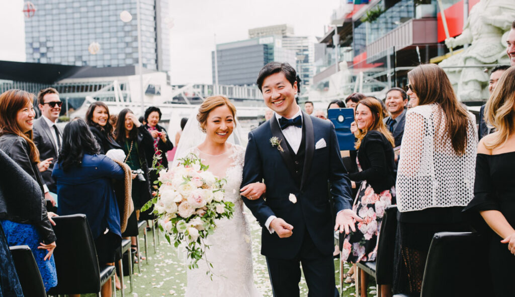 A couple looking happy walking down the aisle